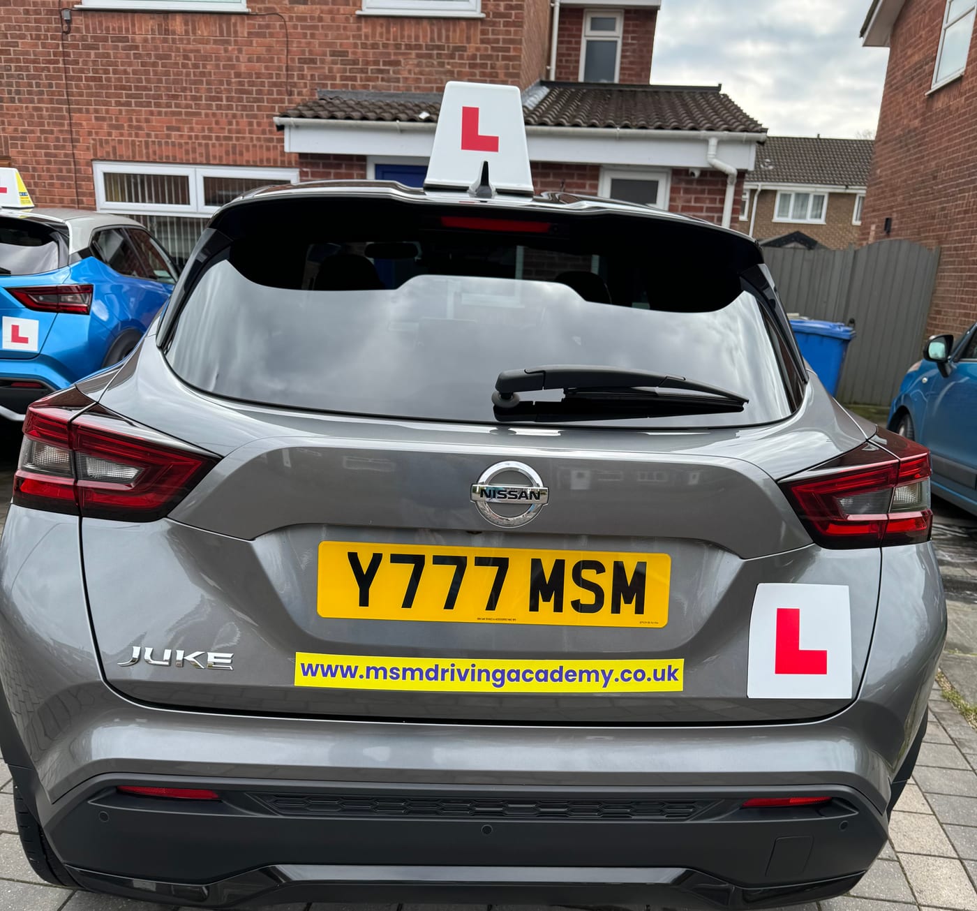 The rear of the grey Nissan Juke showing the MSM Driving Academy web address