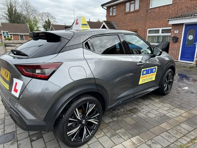 The grey Nissan Juke from the rear three-quarter